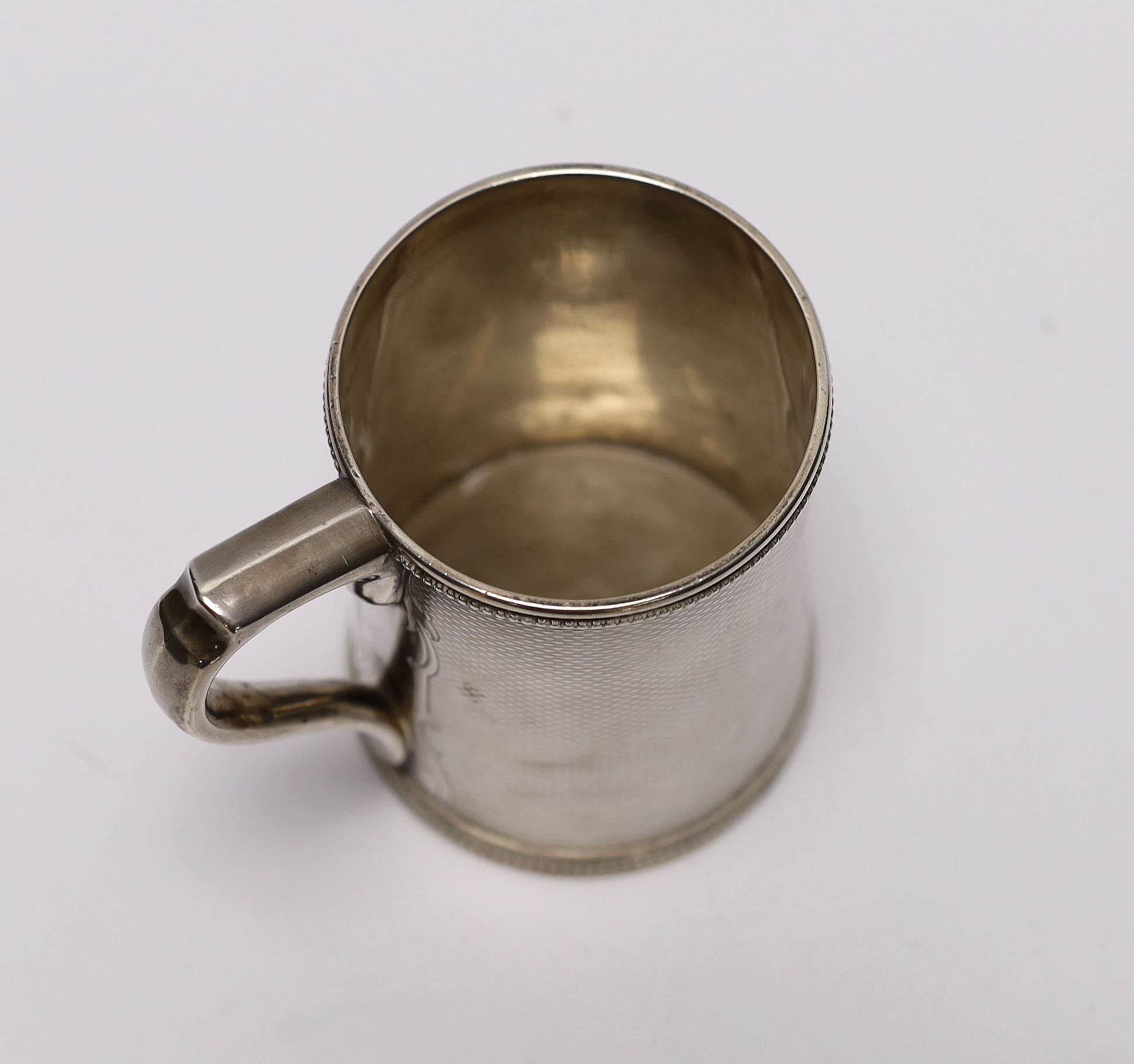 A mid 19th century Tiffany & Co (Grosjean & Woodward) engine turned sterling mug, with engraved inscription, 97mm, 6.9oz.